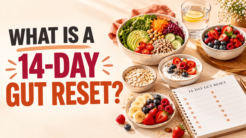 A large salad bowl with avocado, chickpeas, quinoa, shredded carrot and beet, next to bowls of oats, chia yogurt, and mixed berries, and a spiral notebook headed "14-Day Gut Reset" with a numbered 1–14 checklist